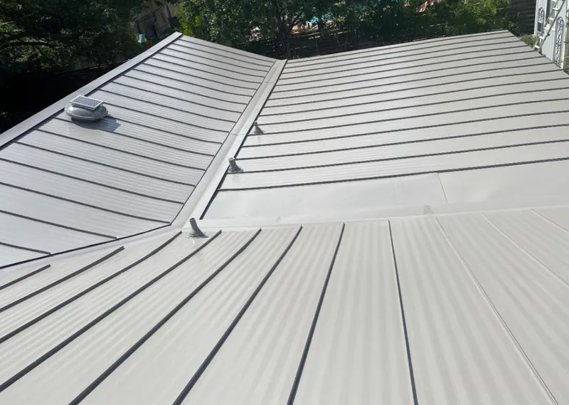 Solar attic fan installed on a metal roof for Roof Ventilation in Stillwater